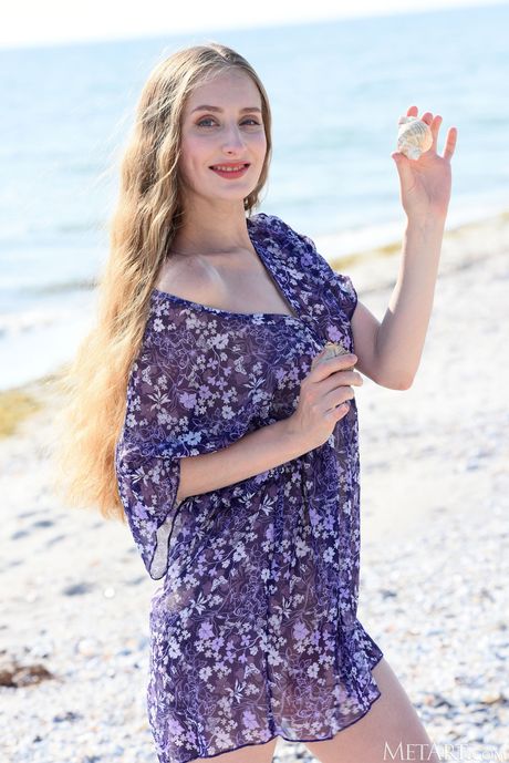 Ukrainian venus Erin Pink gets naked on the beach and demonstrates her tiny tits