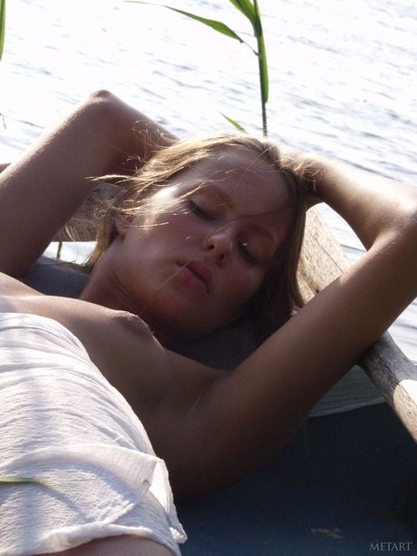 Blonde teen Models No Name gets naked on a boat in the ocean