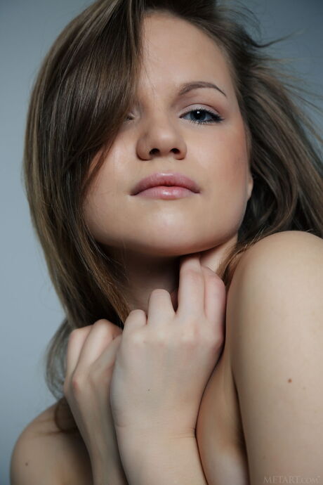 Sexy brunette Isabela demonstrates her big tits and poses in high heels