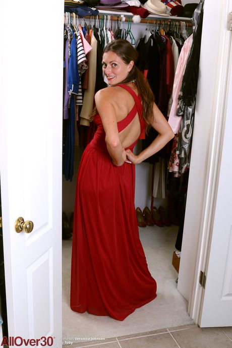 Over 30 blonde Veronica Johnson takes off everything on a bed in a black dress