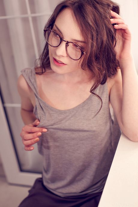 Pretty teen Una Piccola strips to her socks and teases with her big tits