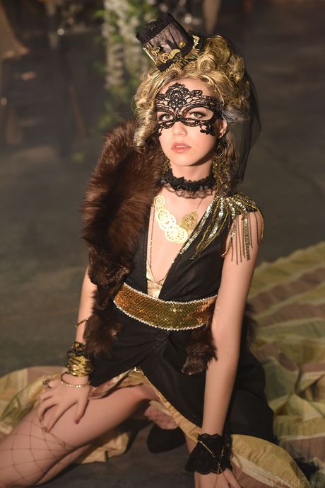 Russian cutie Lily Sands removes a mask and a dress to get naked