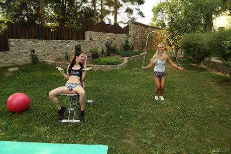 Sporty twins Kristy Black & Lola Myluv play with a double dildo in the yard