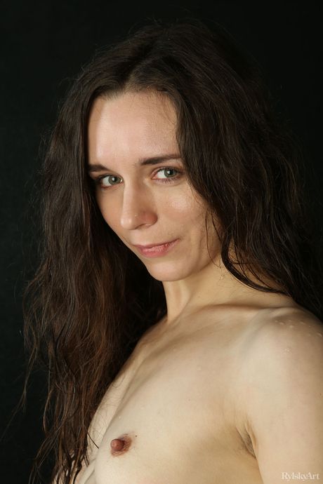 Pretty teen Iris strips off while watering plants in a garden