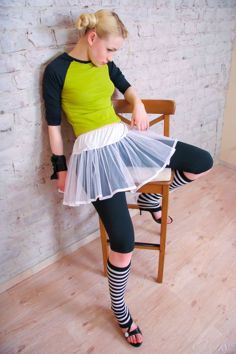 Blonde teen Olya N gets naked in over the knee socks during a dance performance