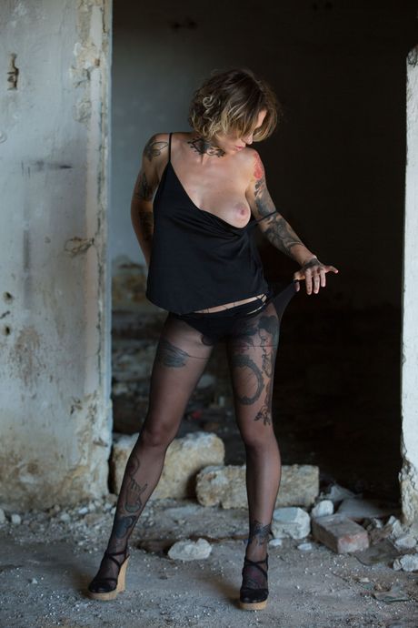 Blonde teen Stacy Cloud gets naked in a building while wearing pantyhose