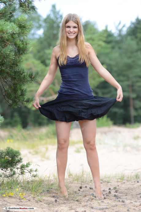 Petite teen Vibeke gets naked in a dress before showing her bald pussy