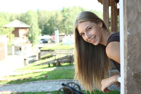 Blonde teen Katherine A fingers her pussy on a blanket in a forest