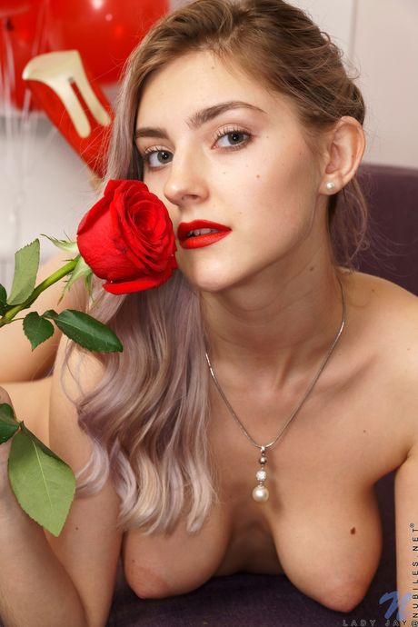 Blonde girl Lady Jay removes red lingerie before masturbating with a toy