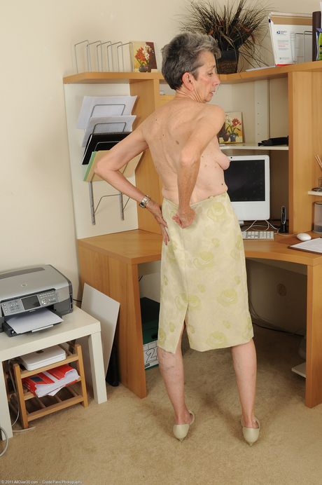 Skinny granny Cassie strips at the office and shows her hairy holes