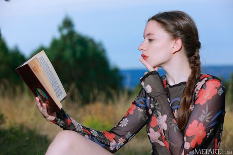 Petite teen Dariana gets totally naked on a blanket in a field