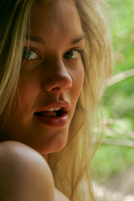 Blonde teen Lisa removes a black dress to pose nude in her bedroom