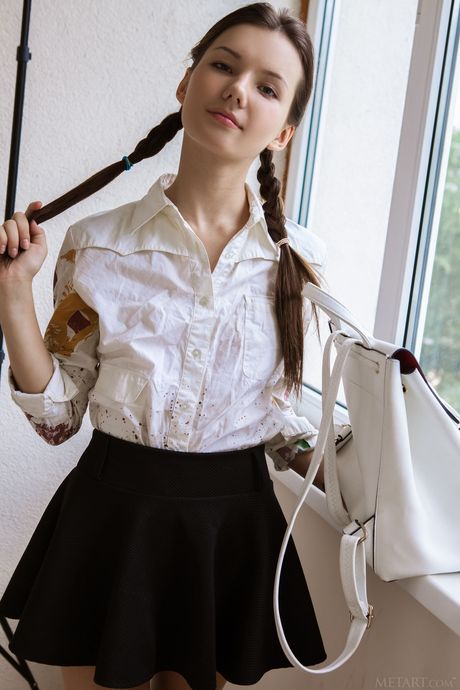 Gorgeous teen Iva removes her pigtails and skirt to pose nude in the kitchen