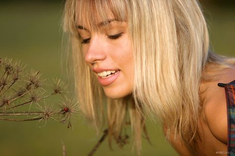 Naked teen Natalia B strikes great solo poses on a patio in the shade