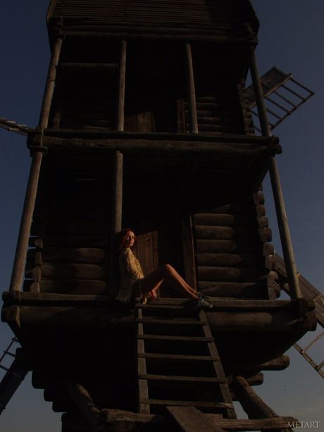 Young redhead Models No Name bares it all on a rocky outcropping