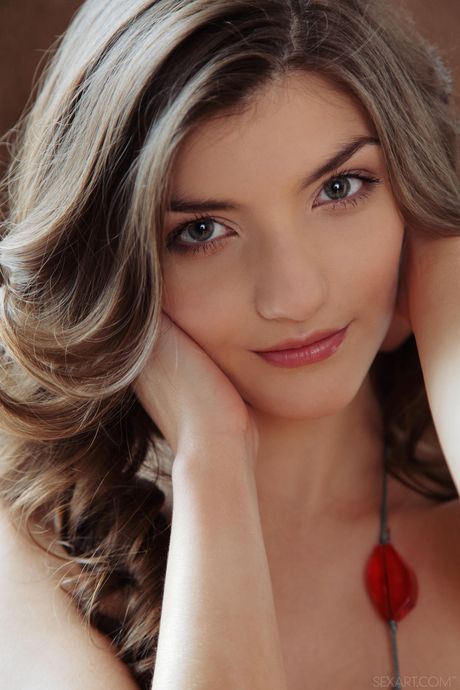 Ukrainian cutie Ryanel A fingers her shaved pussy while naked on a bed