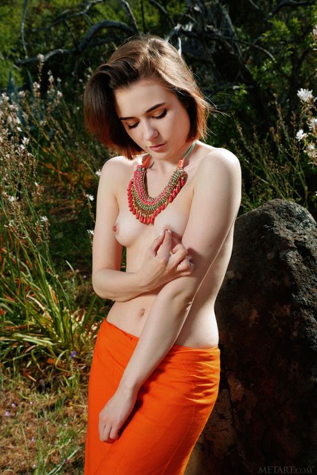 Innocent teen Alice Shea models totally naked in a garden while wearing