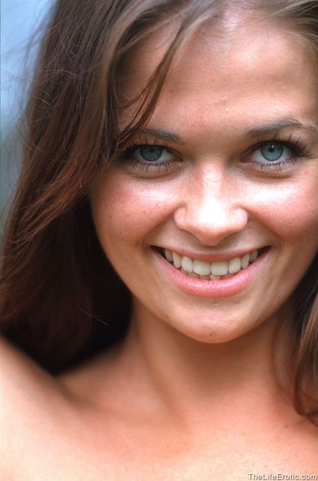 Young brunette Barbara gets naked while smoking a cigarette in the backyard