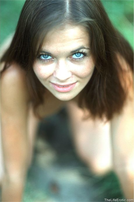 Young brunette Barbara gets naked while smoking a cigarette in the backyard