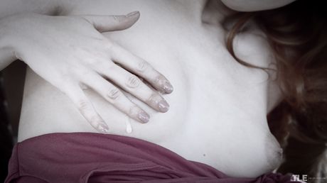 Sexy redhead Amarna Miller removes a leg spreader bar before masturbating