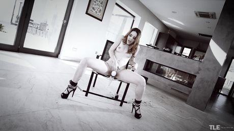 Sexy redhead Amarna Miller removes a leg spreader bar before masturbating