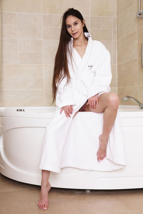 Lean teen Leona A masturbates in the shower while wearing a towel