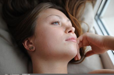 Skinny blonde teen Liza gets naked enticingly