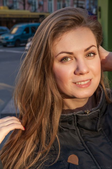 Redheaded teen Milliki removes a bikini to pose nude in a pair of socks