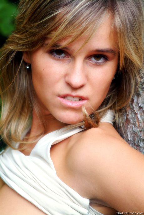 Young blonde Romana fingers her pussy on a balcony after getting naked