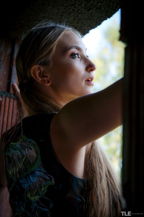 Blonde teen Hannah A gets naked in a dirt road while wearing PVC panties