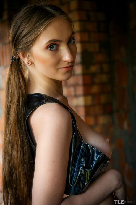 Blonde teen Hannah A gets naked in a dirt road while wearing PVC panties