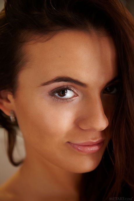 Brunette teen Vanessa Decker removes a white sweater to get naked in heels