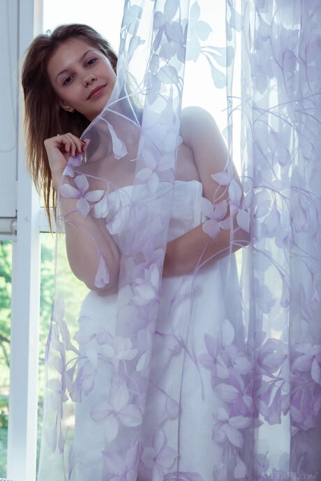 Ukrainian erotic model Emma Sweet exhibits her tiny tits and poses naked