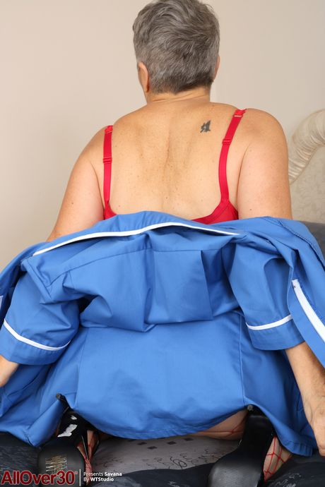 Mature granny Savana removes her uniform and poses in her lingerie