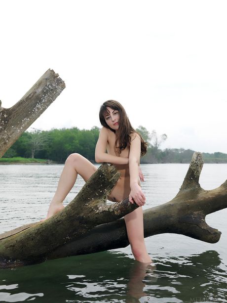 Lean teen Lorena B models totally naked in a shallow pool