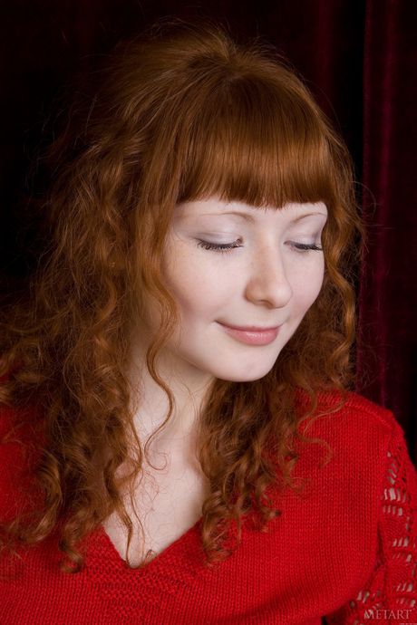 Sexy redhead Rochelle A unveils her big tits and poses naked in a solo