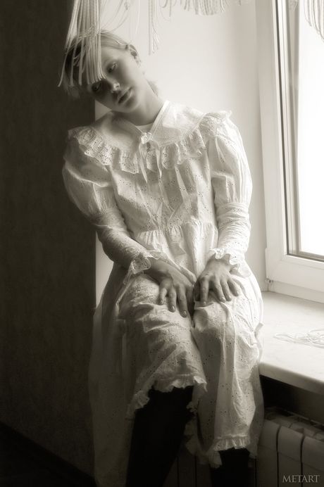 Young blonde Koika gets naked in white stockings and garters