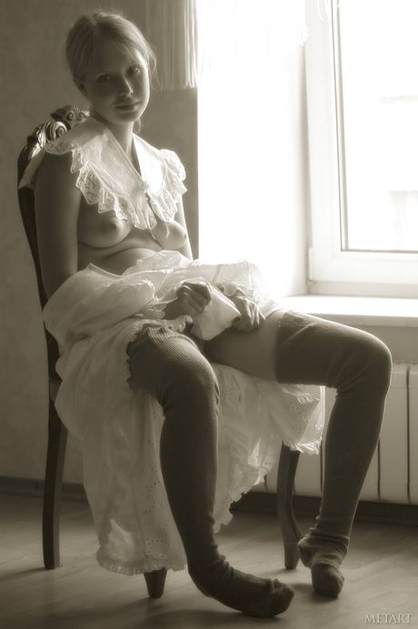 Young blonde Koika gets naked in white stockings and garters