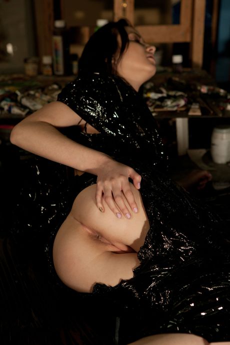 Young brunette Zara D removes a black wrap to get naked in her bedroom