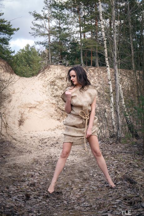 Young brunette Maria Z gets naked on a rope in a forest clearing