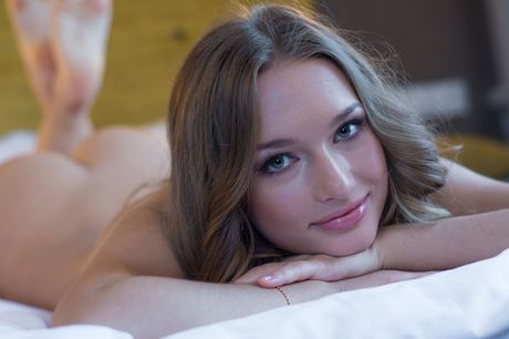 Ukrainian babe Amy Moore poses naked on her bed and shows her pink pussy