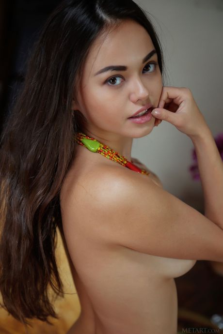 Endearing teen Li Moon demonstrates her big tits and bald pussy in the nude