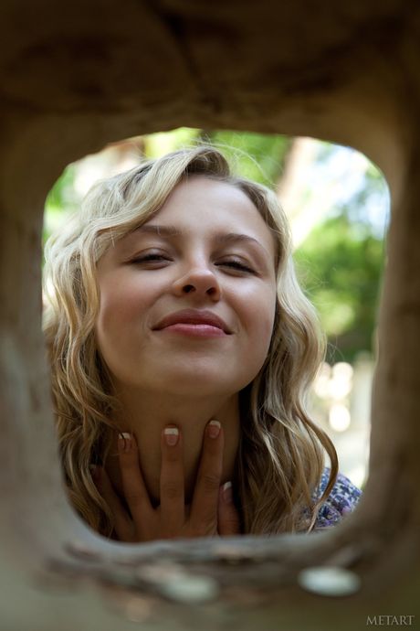 Blonde teen Luciana A gets naked on a bench in a public park