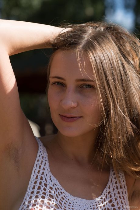 Nice teen Lenta shows her hairy pussy while naked by a river