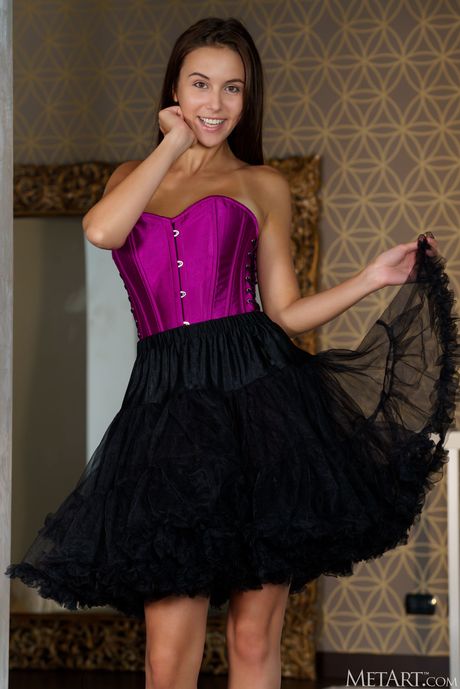 Alluring teen Alisa Amore removes a corset and petticoat to get naked