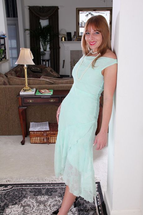 Mature lady Amber Jeanette toys her pussy with a pearl necklace