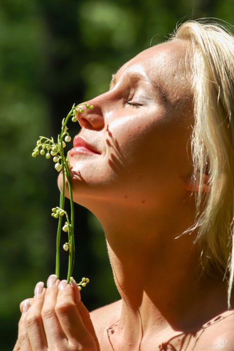 Young blonde Vanessa S models totally naked in a field of wildflowers