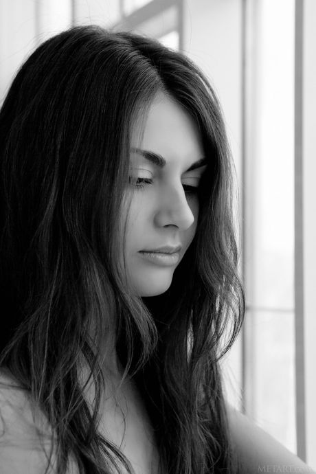 Latina teen Astrud A removes her bra and panties to pose nude