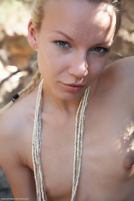 Slender teen Gwyneth models totally naked on a rocky outcrop in a solo