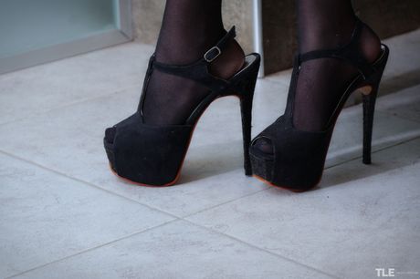 Petra strips off her sexy lingerie and teases her hairy pussy with her fingers